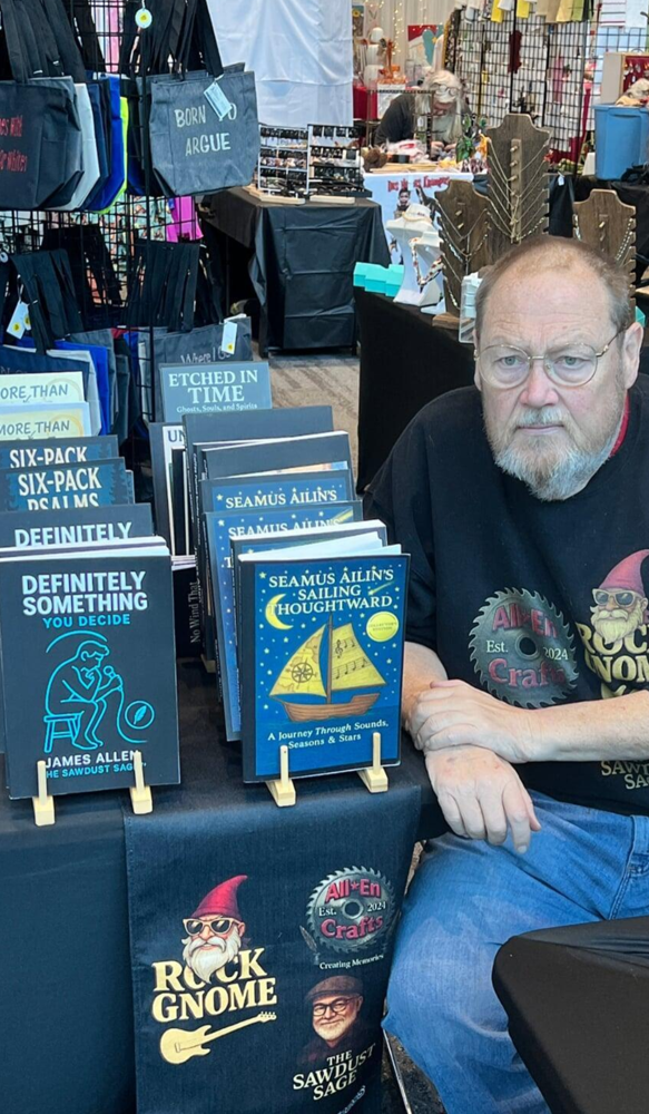 James Allen, The Sawdust Sage™, at a local Iowa market with his books and All En Crafts display.